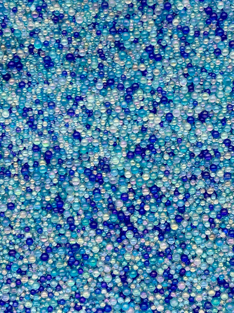 The image is a collage of various blue and white beads, creating a visually striking and vibrant pattern.