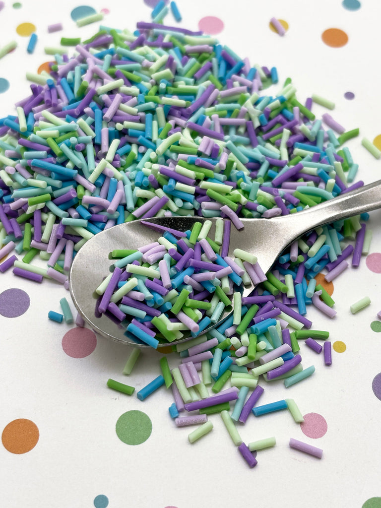 a spoon full of sprinkles on a table