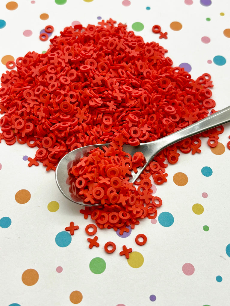 a spoon full of red pasta on a polka dot tablecloth