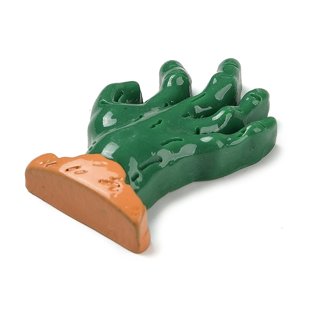 A green, hand-shaped object with a brown, textured end is shown against a white background.