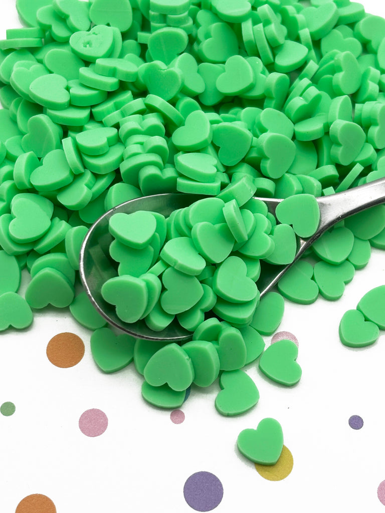 a pile of green hearts sitting on top of a table