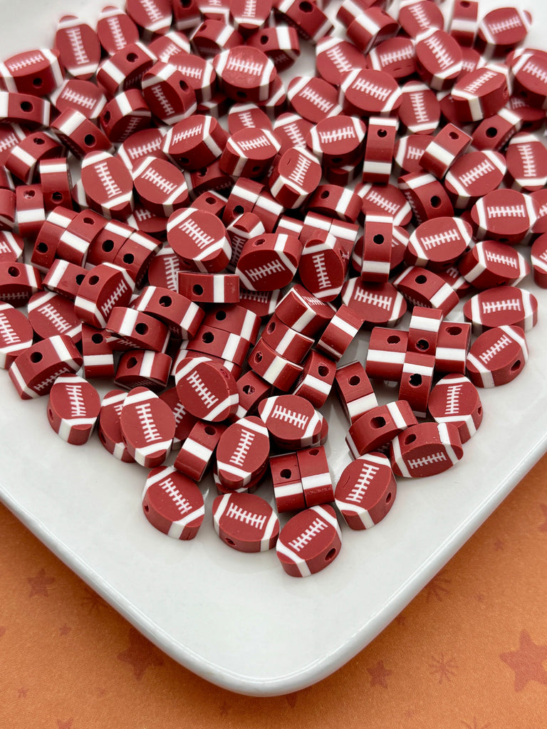 a white plate filled with numerous red and white football-shaped beads, arranged in a visually appealing manner.
