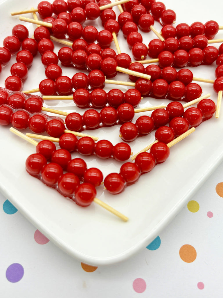 a white plate topped with lots of red candies