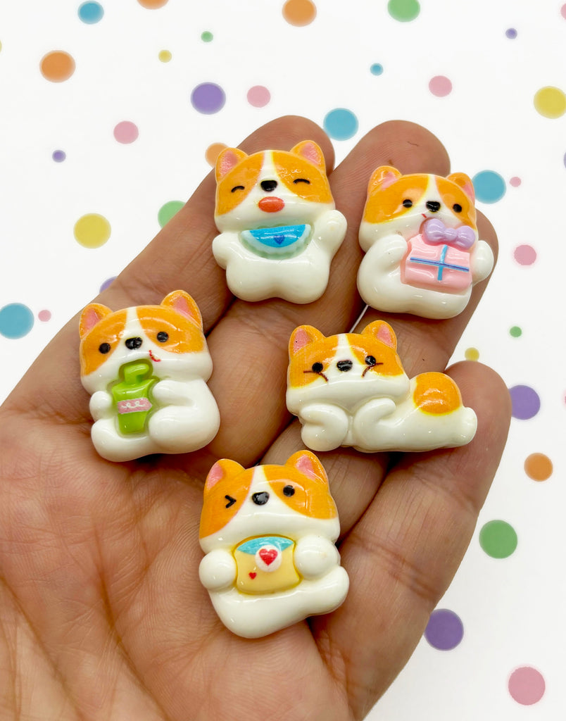 a person holding five small toy dogs in their hand