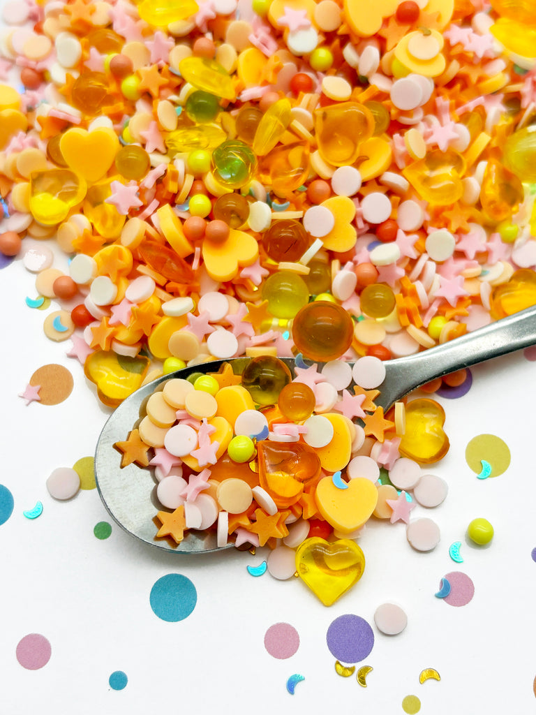 a spoon full of confetti on top of a table