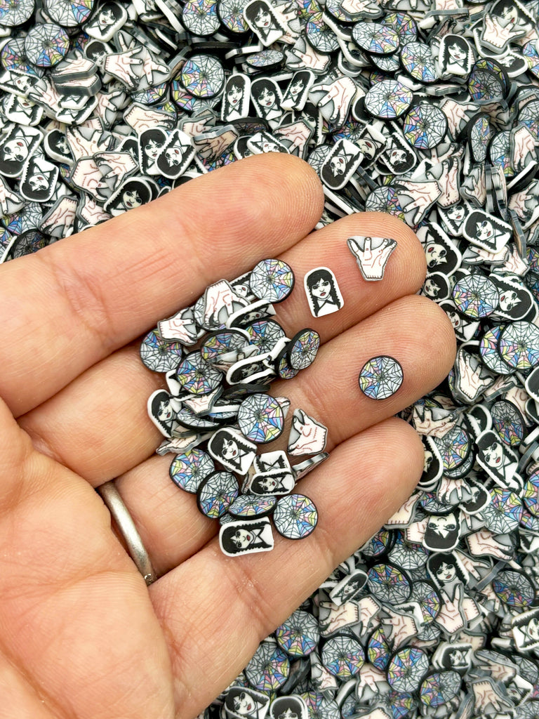 a person holding a bunch of silver rings