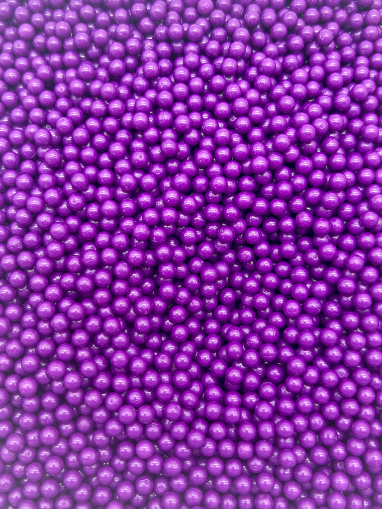 a close up view of a bunch of purple balls