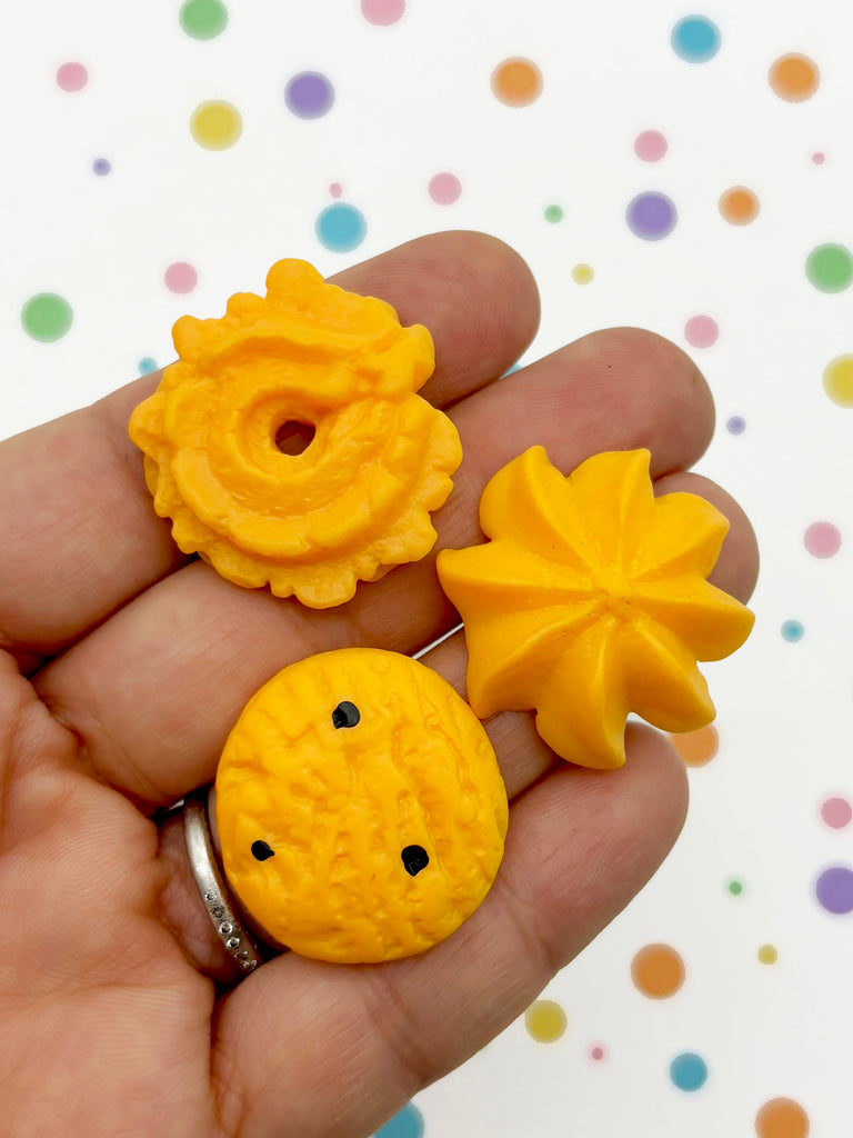 a hand holding a yellow plastic object in it's palm