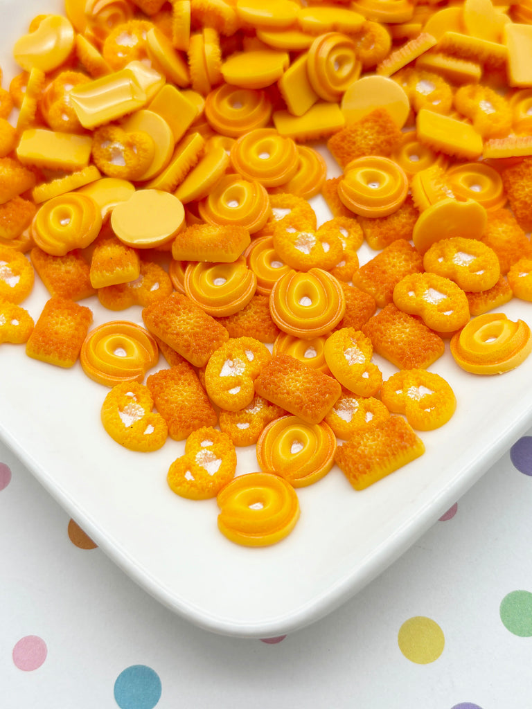 a white plate topped with lots of yellow candies