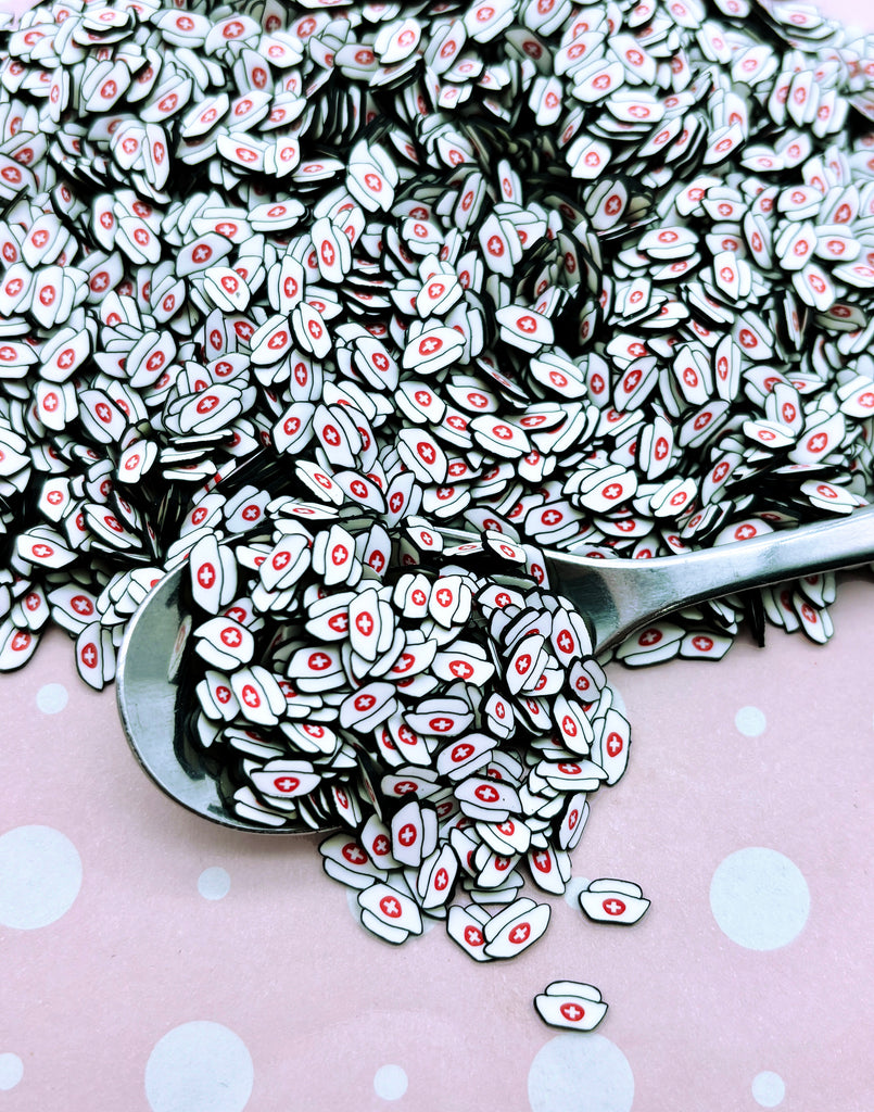 a pile of white and black buttons on a pink polka dot table cloth