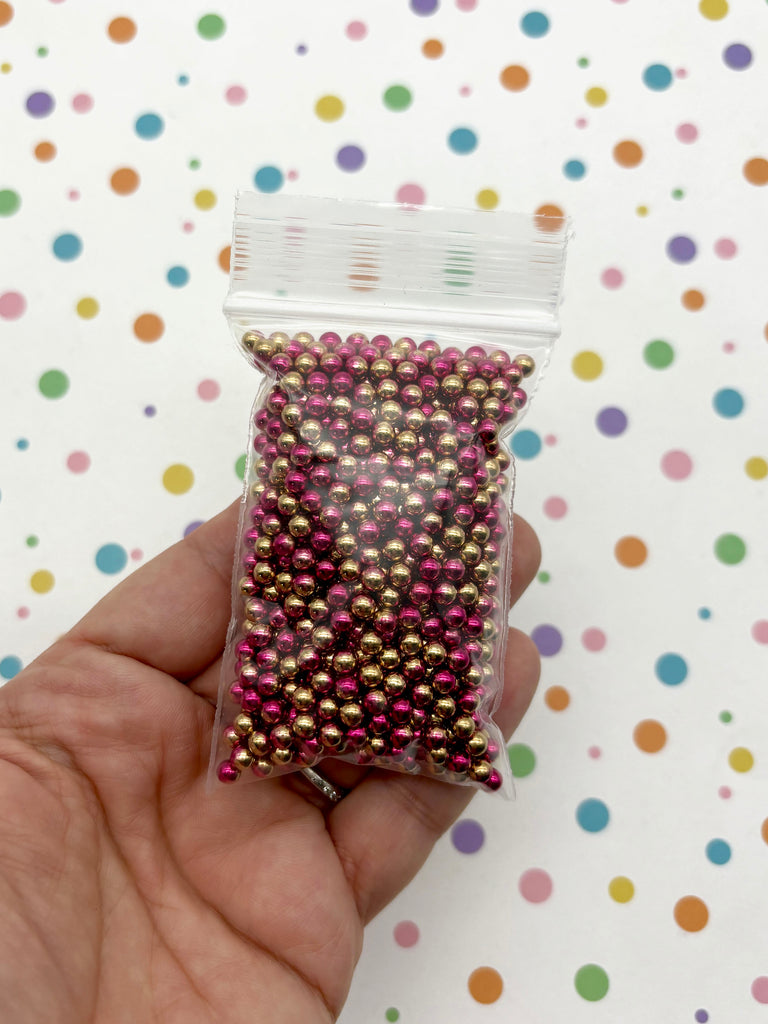 a person holding a bag of beads in their hand