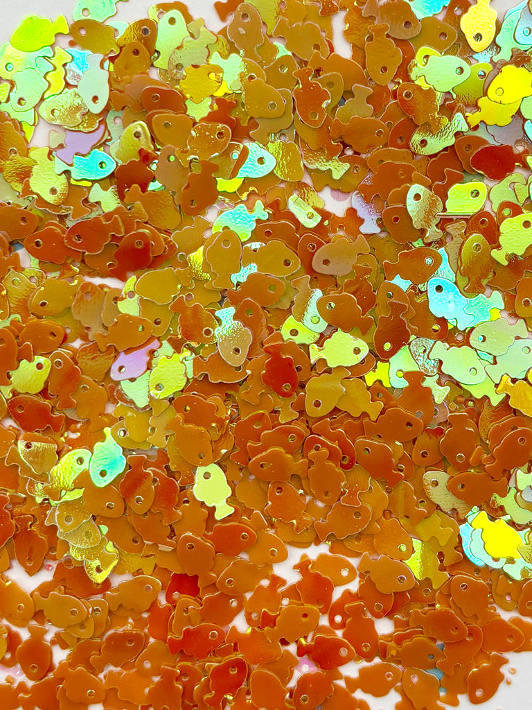 The image is a collage of various shapes and sizes, including small fish-shaped objects, which are scattered across the frame.