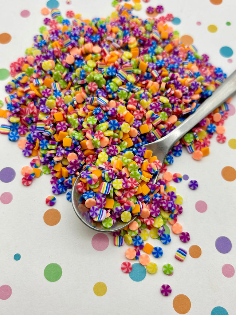 a spoon full of colorful sprinkles on a table