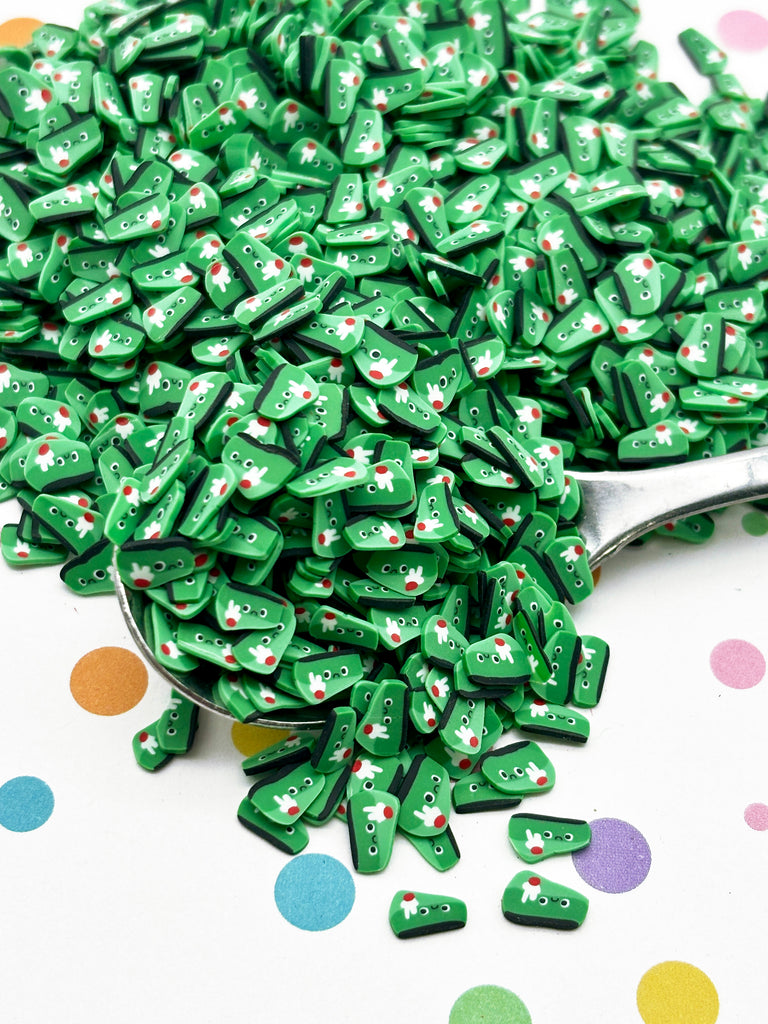 a pile of green buttons sitting on top of a table