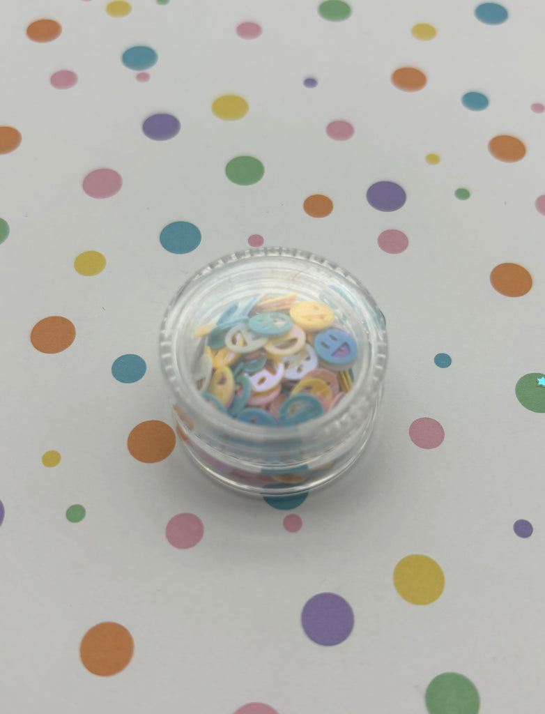 a small container of confetti sitting on a table