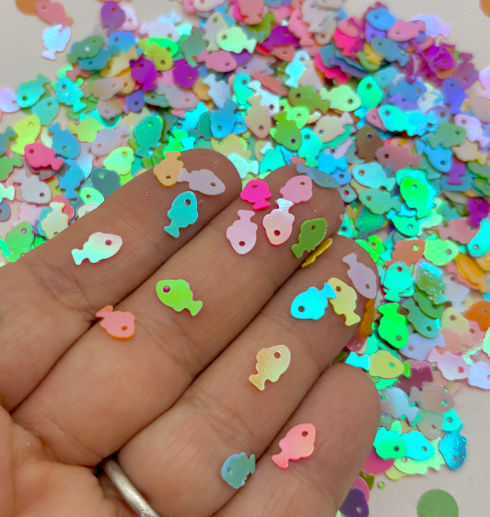 a hand is holding a pile of colorful confetti