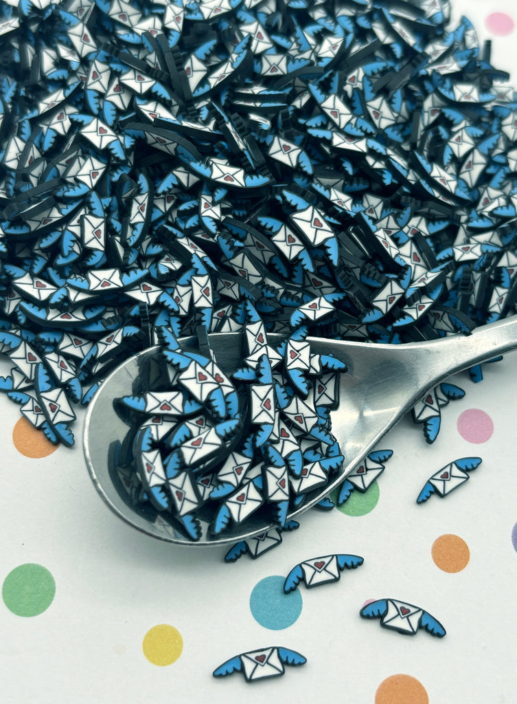 a spoon full of blue origami pieces