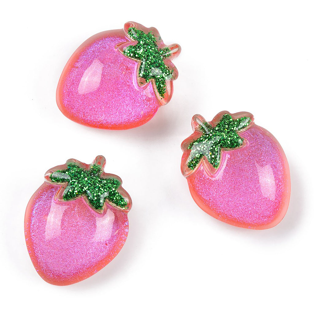 three pink strawberrys with green leaves on them