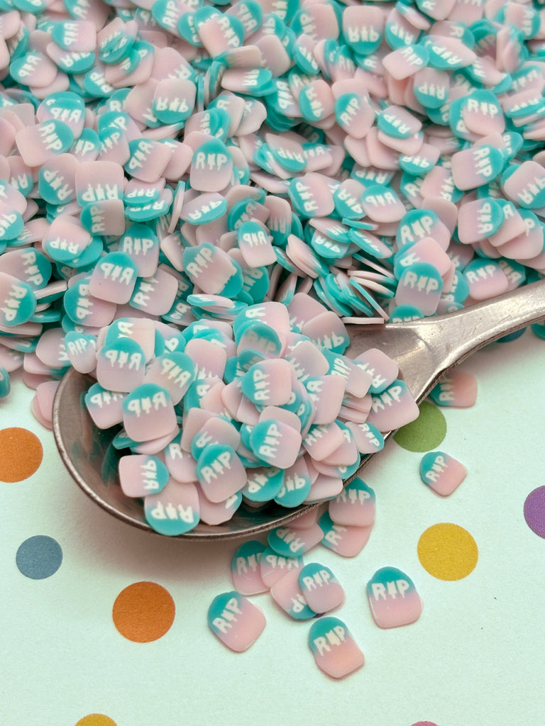 a spoon full of pink and blue candies