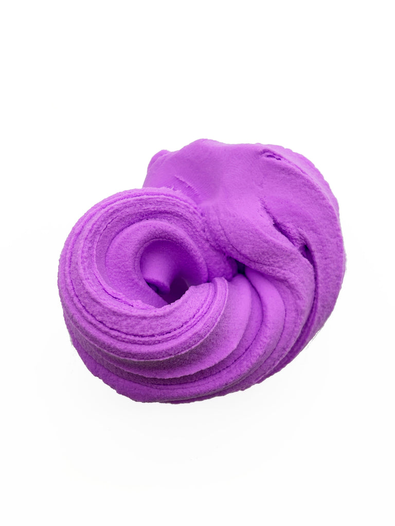 A close-up view of a purple, fluffy substance resembling a type of play dough or a soft, textured material.