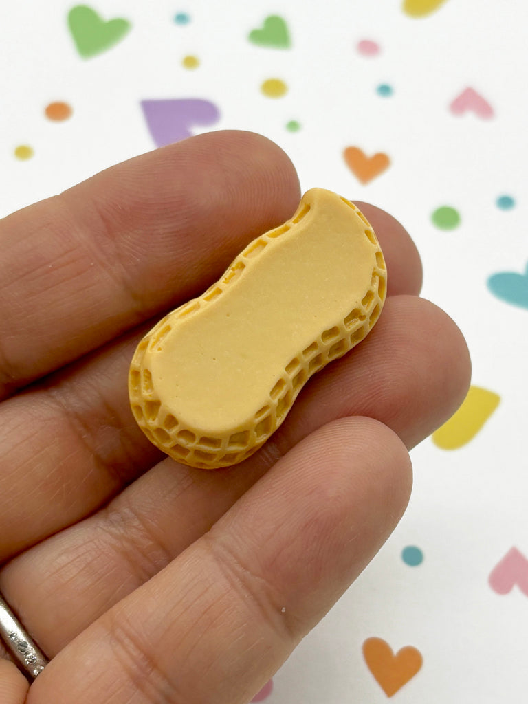 a tiny yellow piece of food in someone's hand