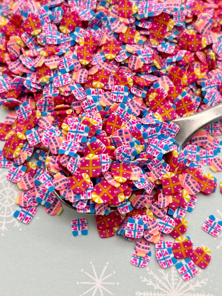 a spoon full of pink and blue sprinkles