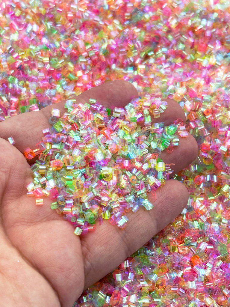 a hand holding a handful of colorful sprinkles