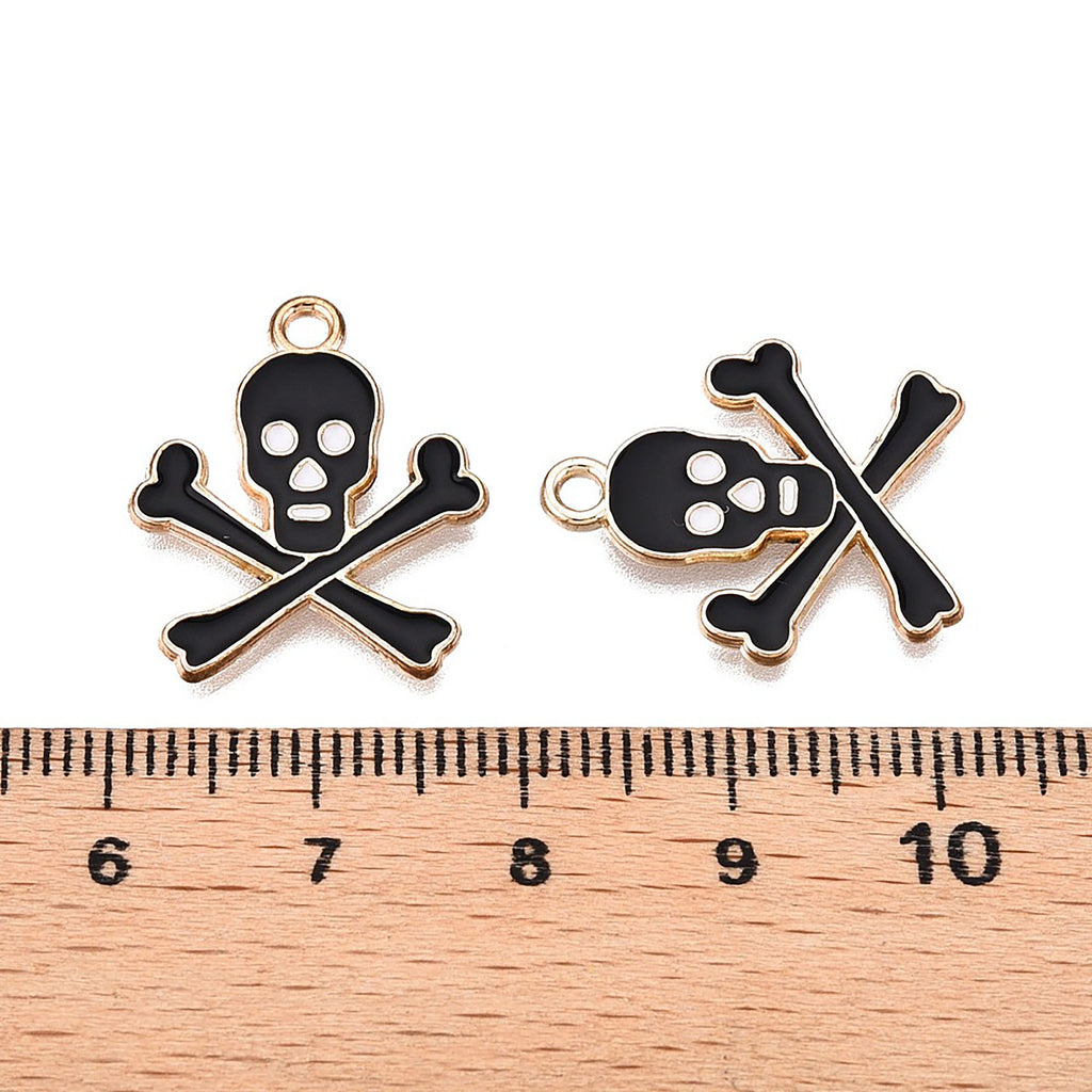 two black and white skull and crossbones charms