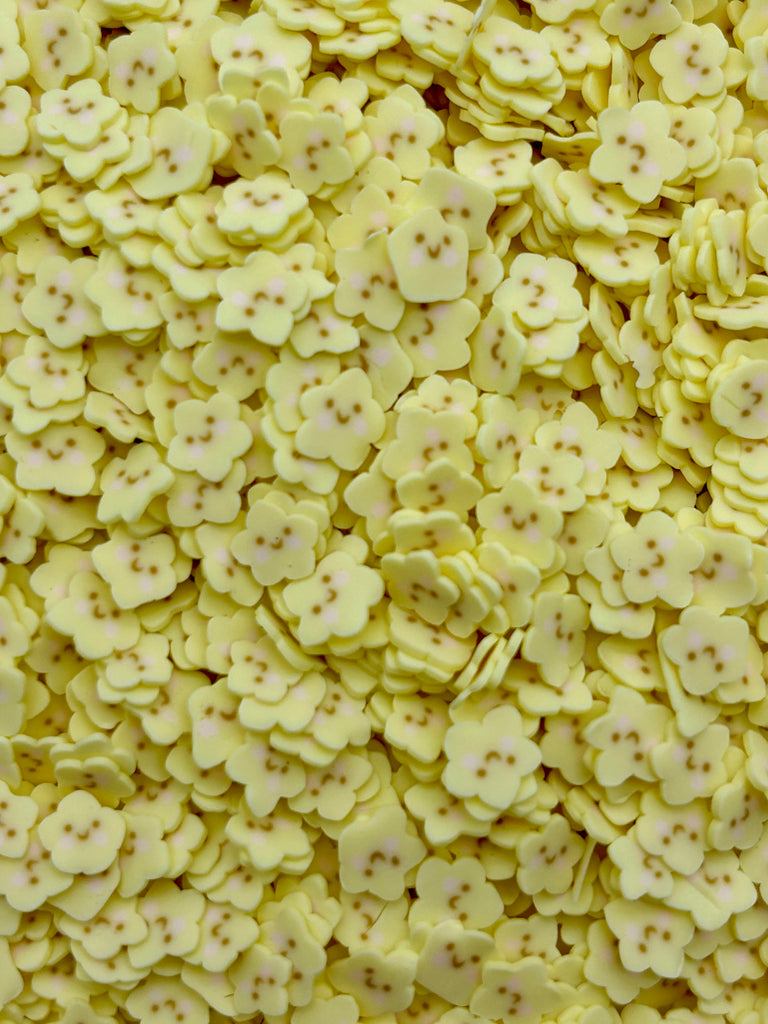 a pile of yellow flowers sitting on top of a table