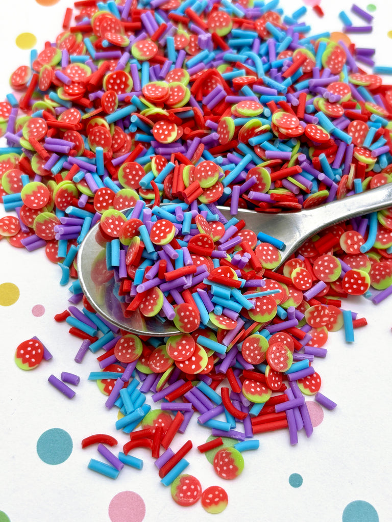 a spoon full of sprinkles on a table