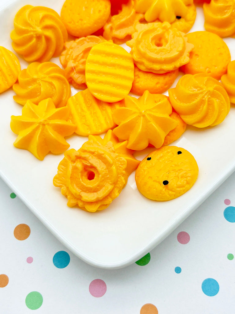 a white plate topped with yellow candies on top of a table