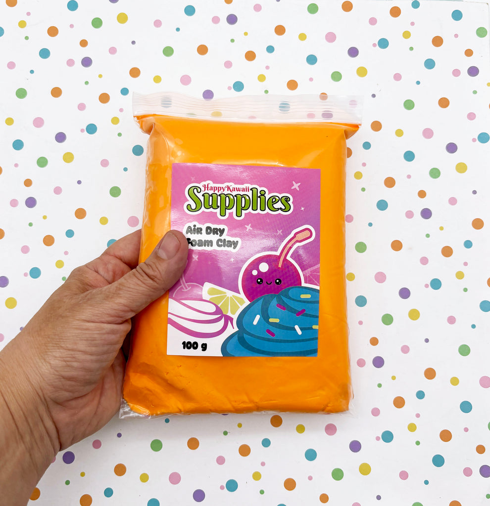 A hand is holding a package of air day foam clay, which is a type of clay used for crafting projects.