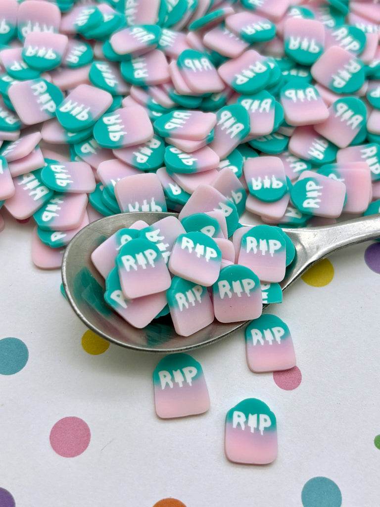 a spoon filled with pink and green conversation hearts