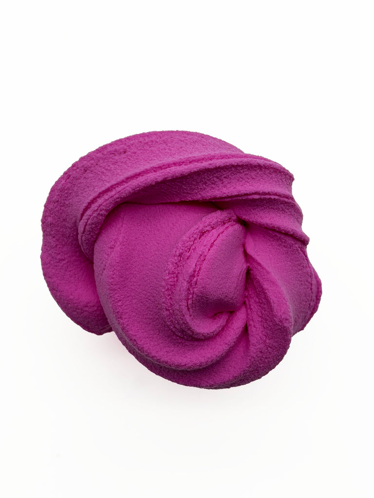 A pink, fluffy, and textured object resembling a cloud or soft, pliable material.