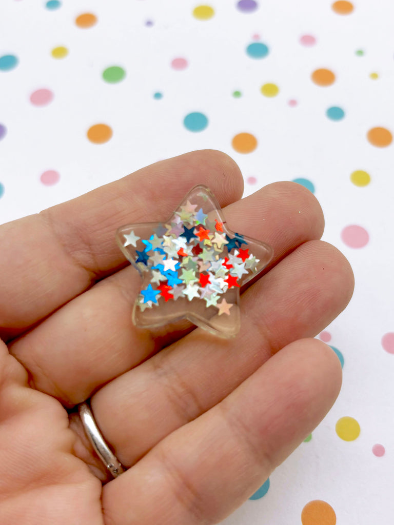 a person holding a star shaped ring in their hand
