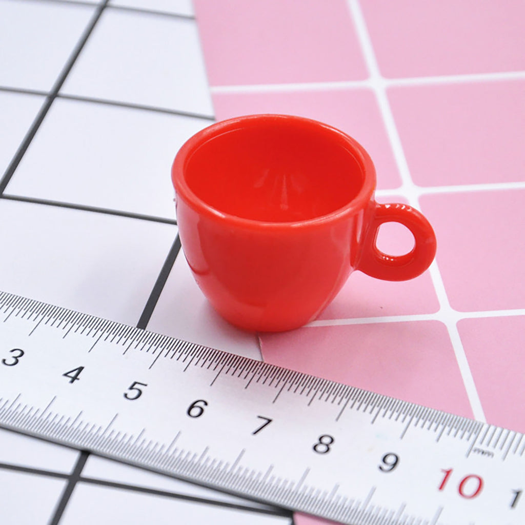 a red cup sitting on top of a ruler