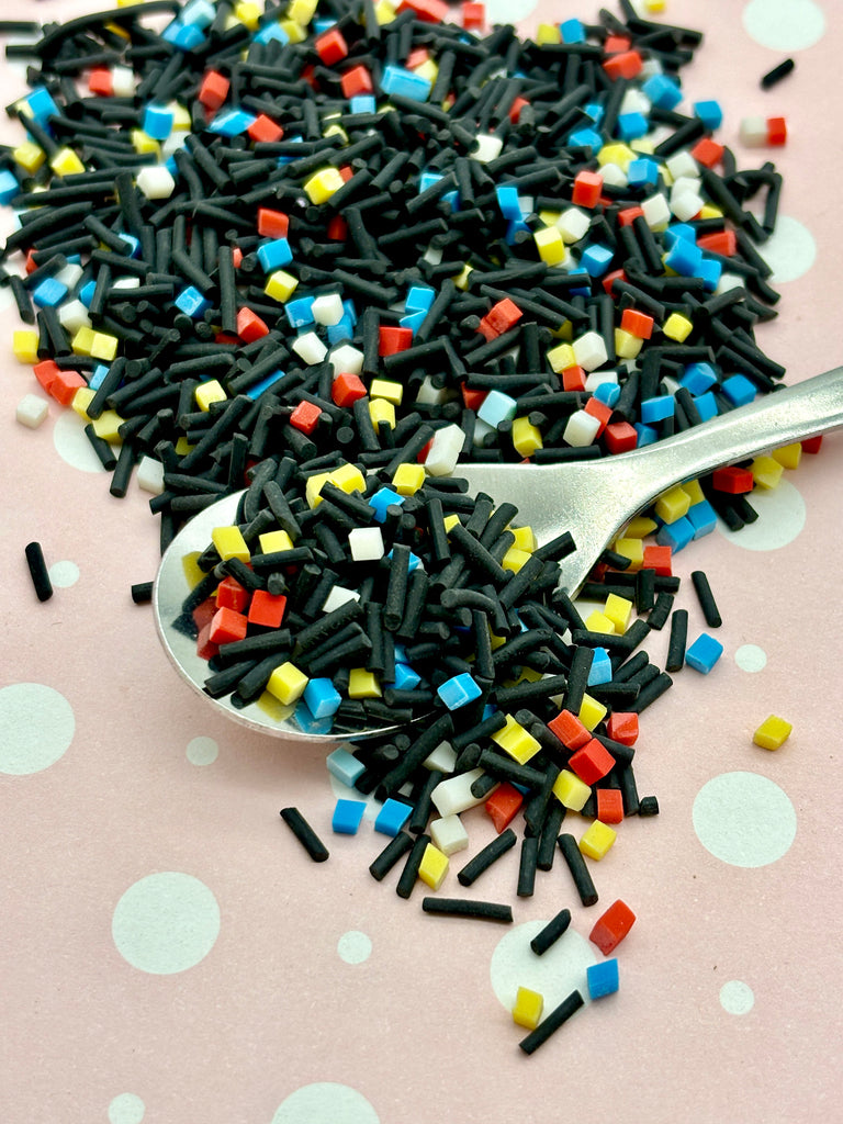 a spoon full of sprinkles on top of a table