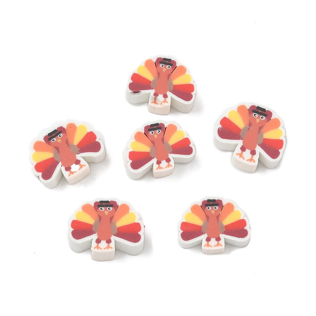 six white erasers with colorful turkey designs on them.