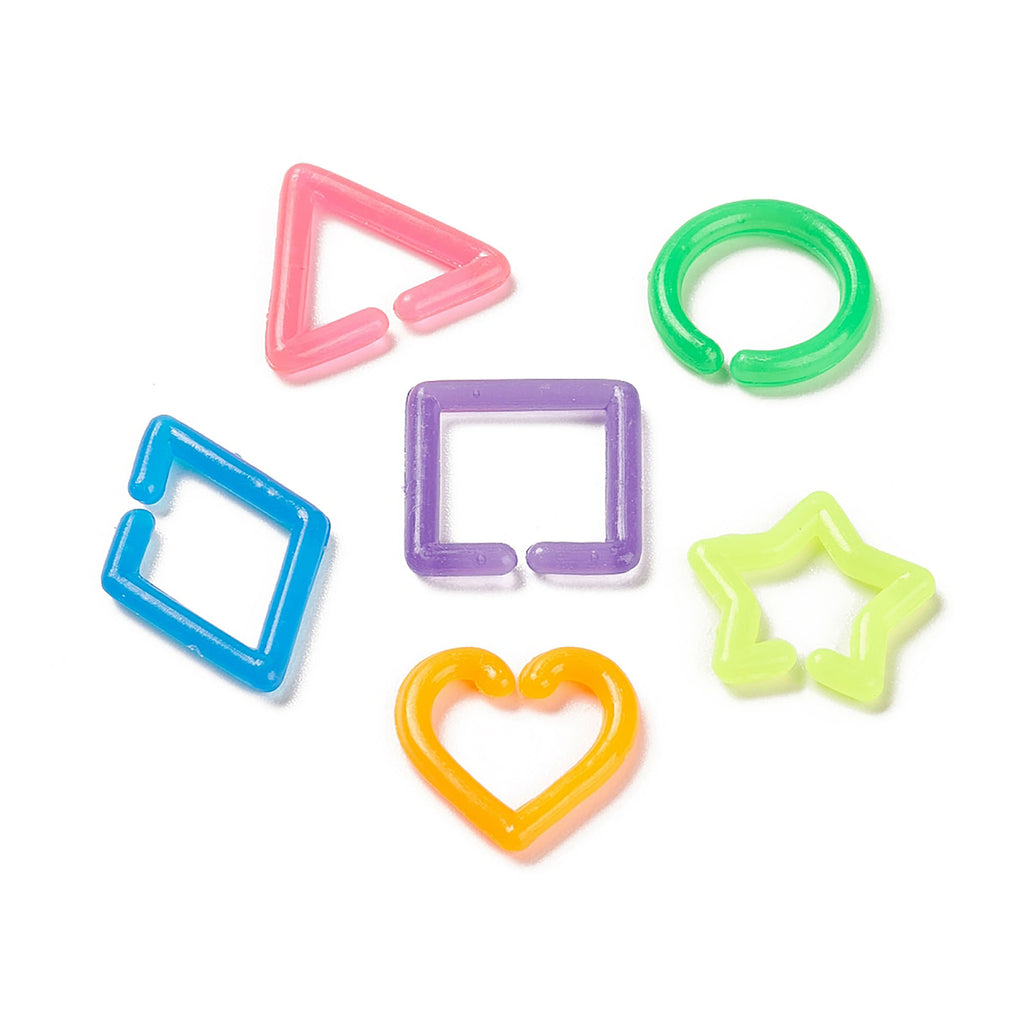 six colorful plastic shapes, including a pink triangle, a green ring, a purple square, a blue diamond, a yellow heart, and a green star.