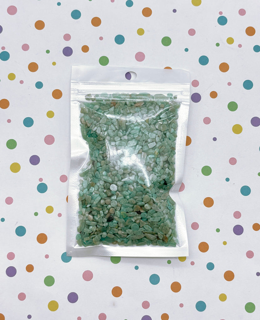 a bag of green rocks sitting on top of a table