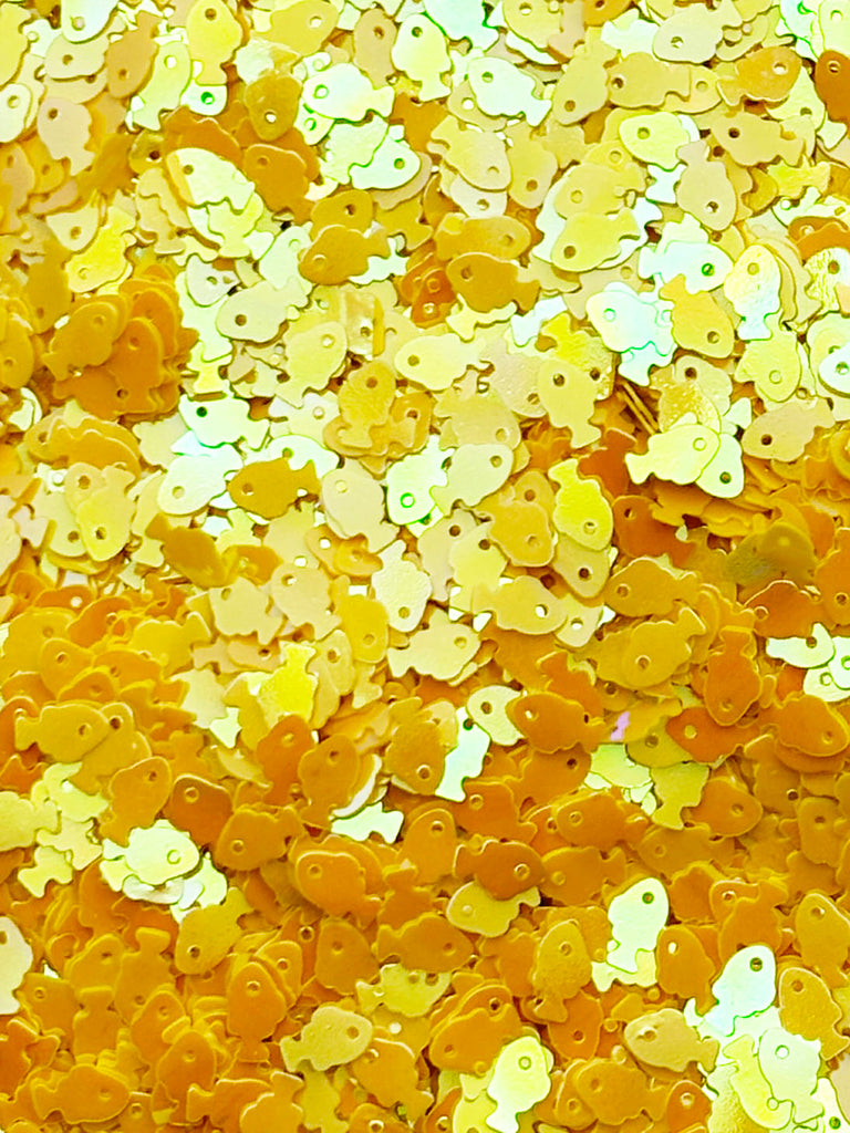 The image is a collage of various yellow and orange fish-shaped sequins or sequins, creating a vibrant and playful visual effect.
