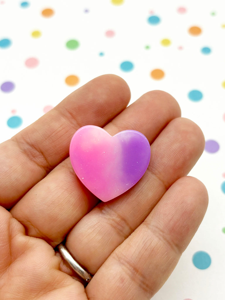 a person holding a heart shaped object in their hand