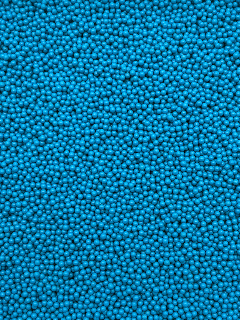 The image is a close-up of numerous small blue beads or spheres, creating a textured and visually striking pattern.