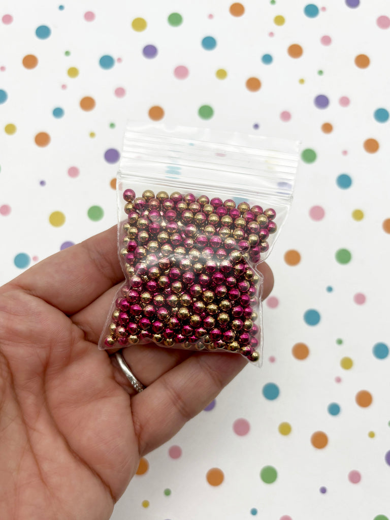 a person holding a bag of beads in their hand