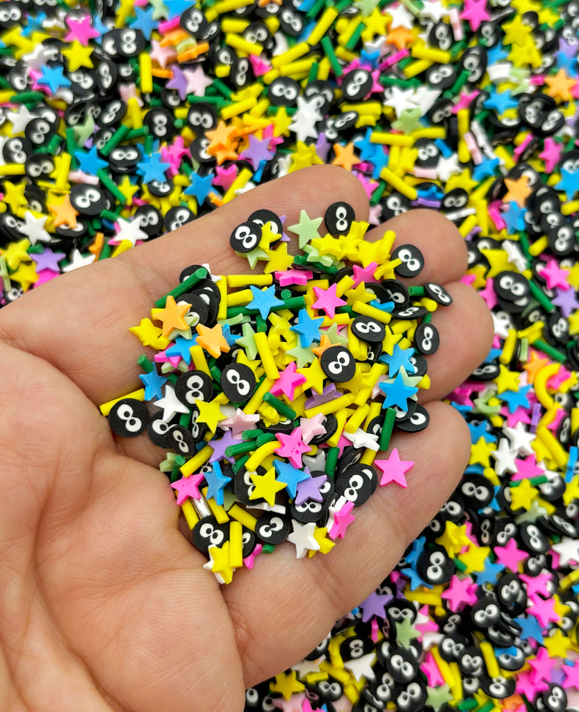 a hand holding a pile of colorful stars and numbers