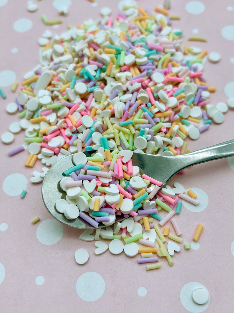 a spoon full of sprinkles on a table