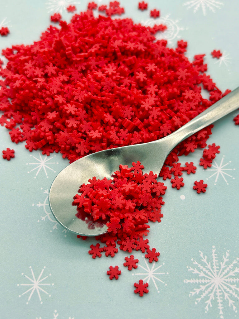 a spoon with red sugar sprinkles on it