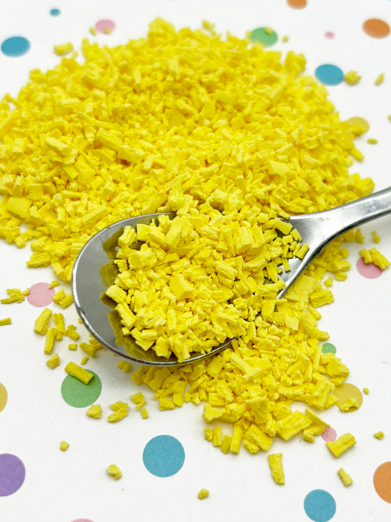 a spoon full of yellow rice on a polka dot tablecloth