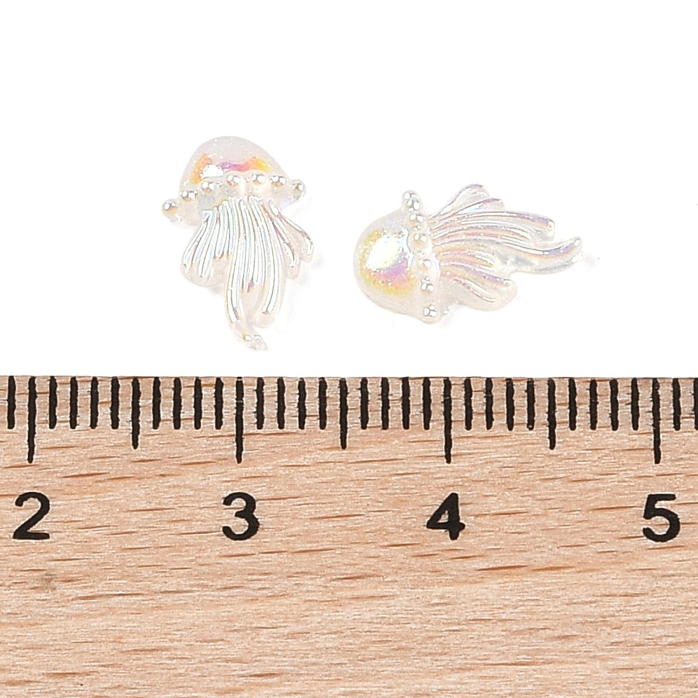 a pair of earrings sitting on top of a ruler