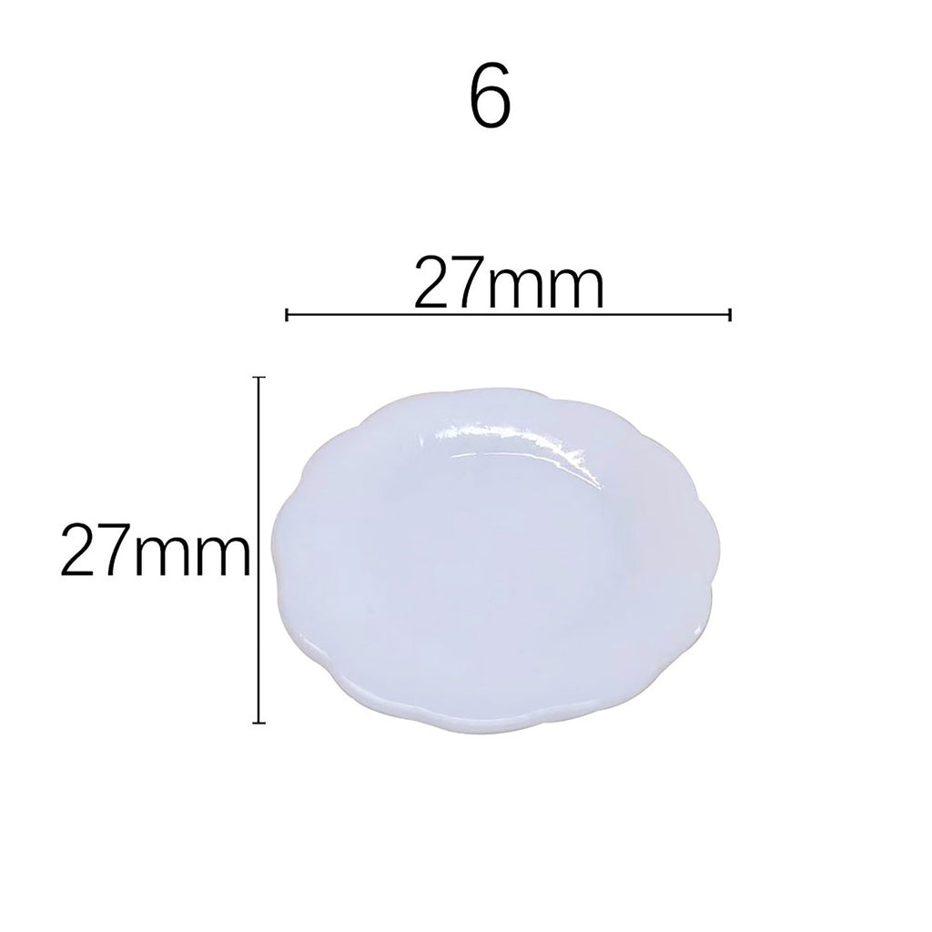 a small white plate with a scalloped edge, and it is described as being 27mm in diameter.